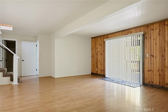 32296 Fern Dr, Running Springs, CA 92382 - unfurnished room featuring wooden walls, light wood-type flooring, stairs, and baseboards