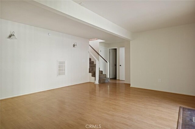 32296 Fern Dr, Running Springs, CA 92382 - unfurnished living room with stairway and wood finished floors