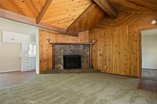 32296 Fern Dr, Running Springs, CA 92382 - unfurnished living room with wooden ceiling, a stone fireplace, baseboards, wood walls, and wood finished floors
