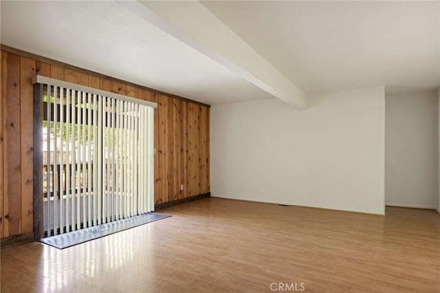 32296 Fern Dr, Running Springs, CA 92382 - empty room featuring wood finished floors, wooden walls, beam ceiling, and baseboards