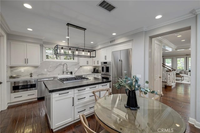 93 Old Course Dr, Newport Beach, CA 92660 - kitchen with appliances with stainless steel finishes, dark wood-style floors, white cabinetry, recessed lighting, and crown molding