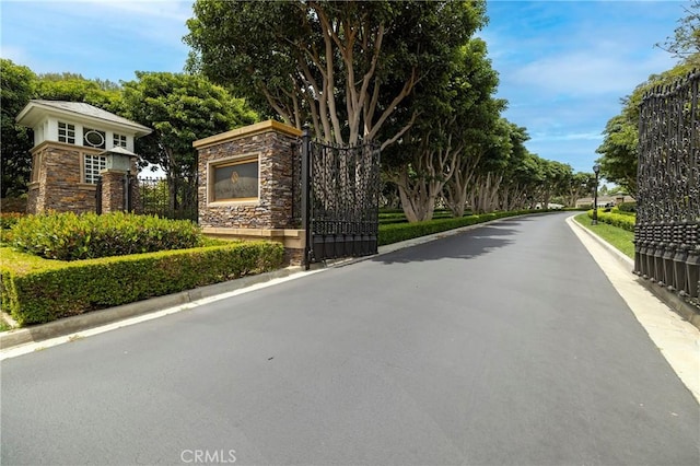 93 Old Course Dr, Newport Beach, CA 92660 - view of asphalt road with curbs and a gate