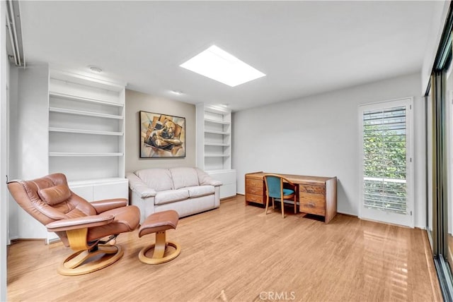 537 Dunnegan Pl, Laguna Beach, CA 92651 - sitting room with light wood-style floors, a skylight, and built in shelves