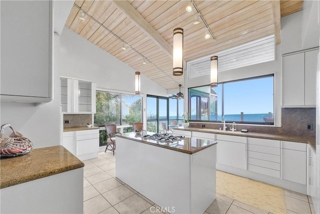 537 Dunnegan Pl, Laguna Beach, CA 92651 - kitchen featuring track lighting, wooden ceiling, a kitchen island, white cabinetry, and white gas stovetop