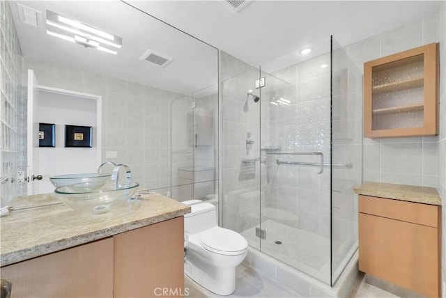 537 Dunnegan Pl, Laguna Beach, CA 92651 - bathroom featuring tile walls, vanity, and a stall shower