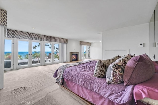 537 Dunnegan Pl, Laguna Beach, CA 92651 - carpeted bedroom featuring access to outside, a glass covered fireplace, and a water view