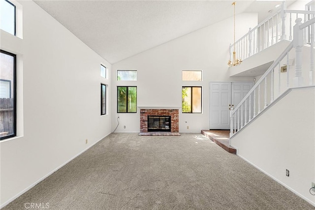 1234 Via Palermo, Redlands, CA 92374 - unfurnished living room with high vaulted ceiling, stairs, carpet flooring, baseboards, and a fireplace