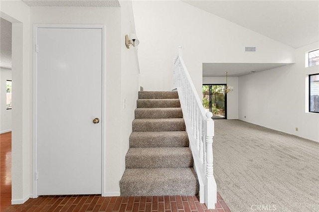 1234 Via Palermo, Redlands, CA 92374 - stairs featuring plenty of natural light, vaulted ceiling, a chandelier, and carpet flooring