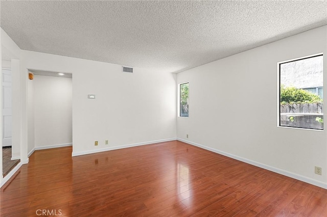 1234 Via Palermo, Redlands, CA 92374 - spare room with wood finished floors, a textured ceiling, and baseboards