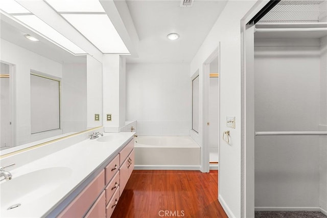 1234 Via Palermo, Redlands, CA 92374 - full bath featuring double vanity, a garden tub, wood finished floors, recessed lighting, and baseboards