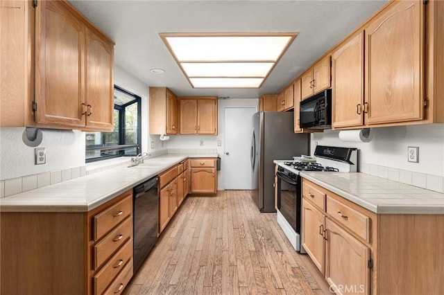 1234 Via Palermo, Redlands, CA 92374 - kitchen featuring black appliances, light wood-style floors, a sink, and light countertops