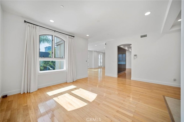 132 S Crescent Dr Unit 202, Beverly Hills, CA 90212 - spare room featuring arched walkways, light wood-style flooring, baseboards, and recessed lighting