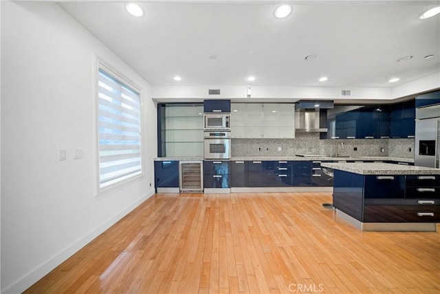 132 S Crescent Dr Unit 202, Beverly Hills, CA 90212 - kitchen with stainless steel appliances, modern cabinets, beverage cooler, decorative backsplash, and a sink