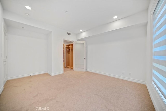 132 S Crescent Dr Unit 202, Beverly Hills, CA 90212 - unfurnished bedroom featuring light colored carpet, a walk in closet, baseboards, recessed lighting, and a closet