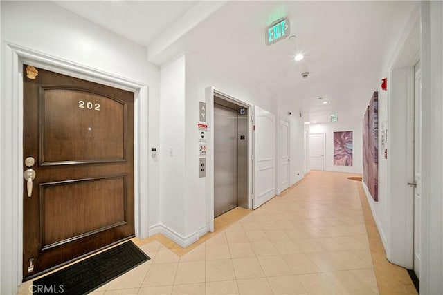 132 S Crescent Dr Unit 202, Beverly Hills, CA 90212 - entrance foyer featuring elevator, light tile patterned floors, baseboards, and recessed lighting