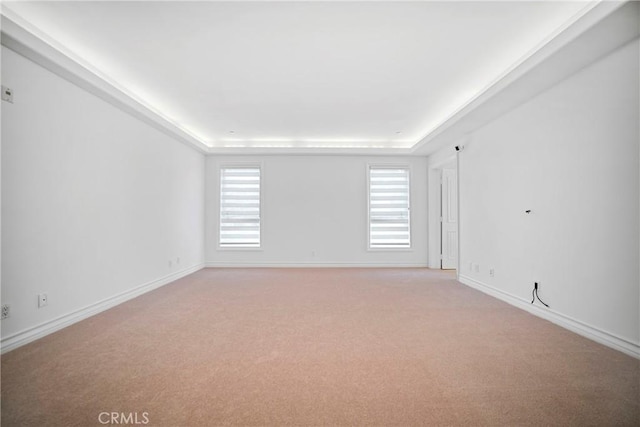 132 S Crescent Dr Unit 202, Beverly Hills, CA 90212 - spare room featuring light carpet, a raised ceiling, and baseboards