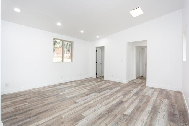 12049 Coping Pl, Lakeside, CA 92040 - spare room with light wood-type flooring, recessed lighting, baseboards, and vaulted ceiling