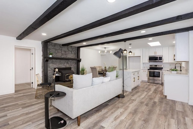 12049 Coping Pl, Lakeside, CA 92040 - living room with light wood-type flooring, beam ceiling, a fireplace, recessed lighting, and baseboards