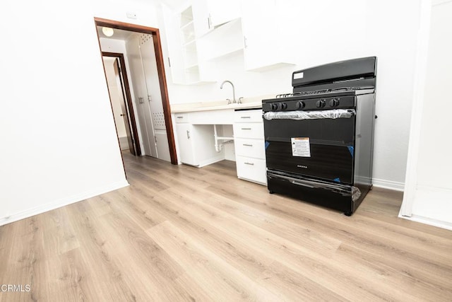2256 Pierpont Blvd, Ventura, CA 93001 - kitchen featuring gas stove, white cabinetry, light wood-style floors, and light countertops
