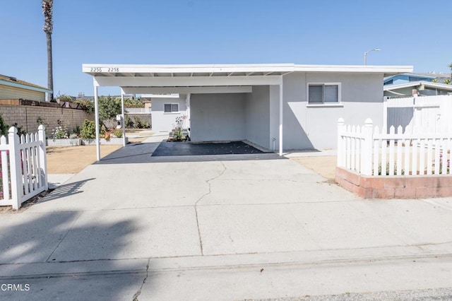 2256 Pierpont Blvd, Ventura, CA 93001 - view of front facade featuring an attached carport, driveway, and stucco siding