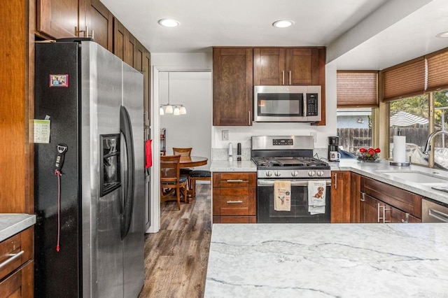 6243 Lake Lomond Dr, San Diego, CA 92119 - kitchen featuring appliances with stainless steel finishes, a sink, wood finished floors, recessed lighting, and light stone countertops