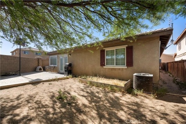 13009 Cerritos Ct, Hesperia, CA 92344 - back of property featuring central air condition unit, a patio, stucco siding, and a fenced backyard
