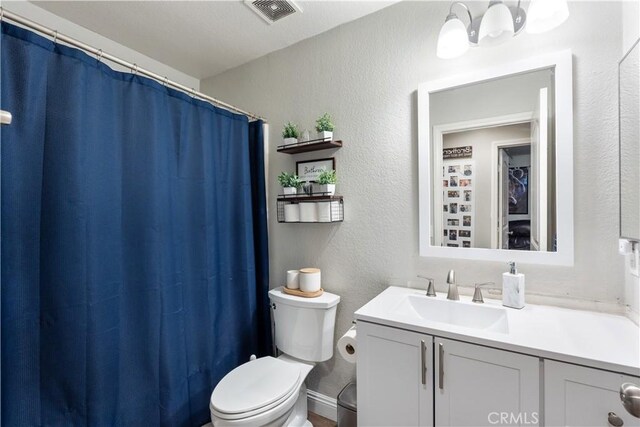 13009 Cerritos Ct, Hesperia, CA 92344 - bathroom featuring toilet, vanity, a textured wall, and a shower with shower curtain