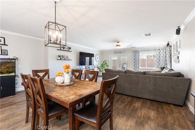 13009 Cerritos Ct, Hesperia, CA 92344 - dining space with ornamental molding, dark wood finished floors, baseboards, a chandelier, and french doors