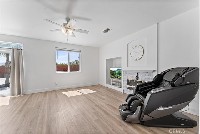 8798 Crest View Dr, Corona, CA 92883 - living area featuring healthy amount of natural light, a ceiling fan, light wood finished floors, and baseboards