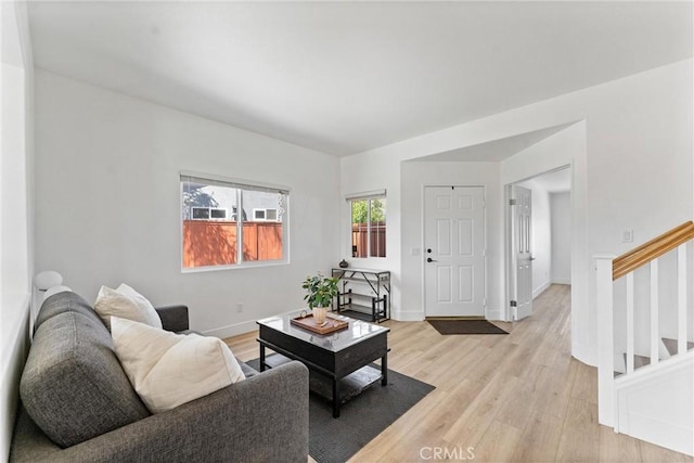 8798 Crest View Dr, Corona, CA 92883 - living area with light wood-style flooring, stairs, and baseboards
