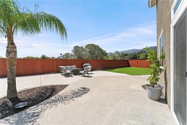 8798 Crest View Dr, Corona, CA 92883 - fenced backyard featuring a patio, a mountain view, and an outdoor living space