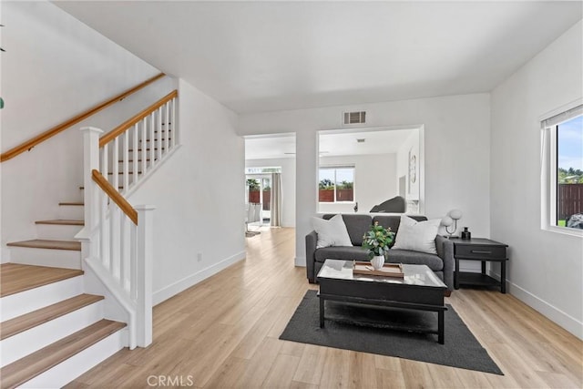 8798 Crest View Dr, Corona, CA 92883 - living area with light wood-style floors, stairs, and baseboards