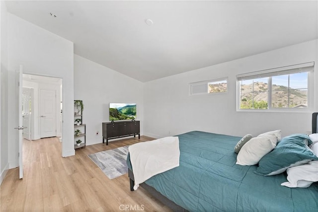 8798 Crest View Dr, Corona, CA 92883 - bedroom featuring light wood-type flooring, vaulted ceiling, and baseboards