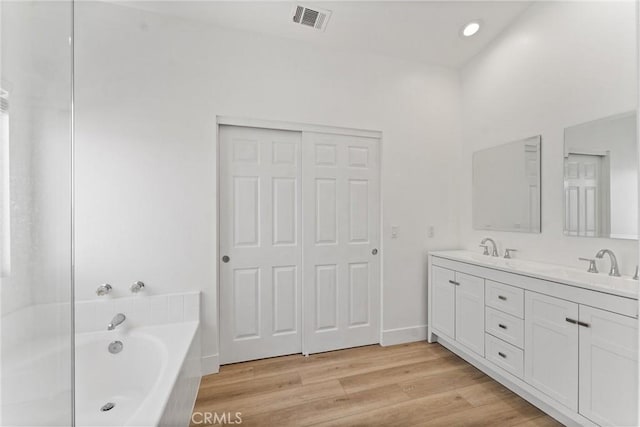 8798 Crest View Dr, Corona, CA 92883 - bathroom with double vanity, a garden tub, wood finished floors, and recessed lighting