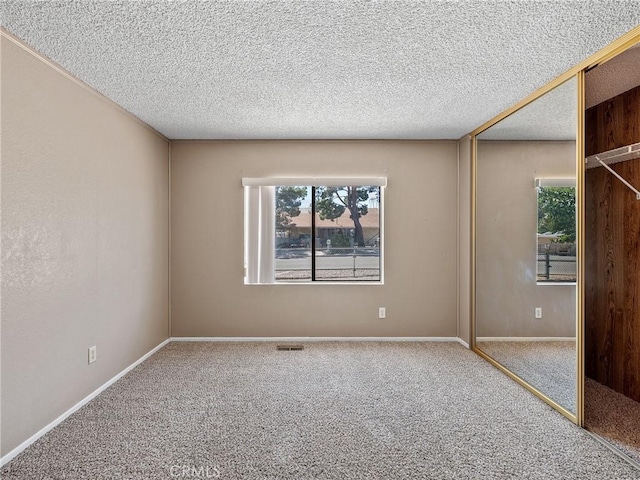 8307 Arrowhead Lake Rd, Hesperia, CA 92345 - spare room with carpet flooring, a textured ceiling, and baseboards
