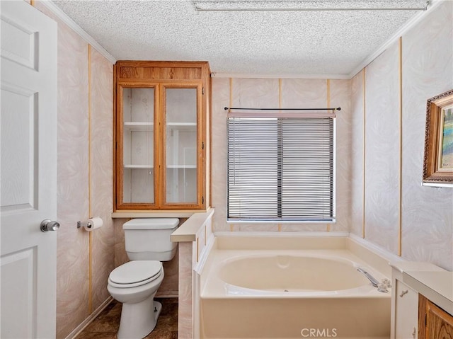 8307 Arrowhead Lake Rd, Hesperia, CA 92345 - bathroom featuring a garden tub, toilet, a textured ceiling, and ornamental molding