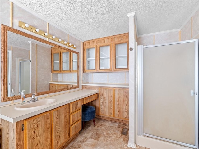 8307 Arrowhead Lake Rd, Hesperia, CA 92345 - bathroom with a shower stall, a textured ceiling, vanity, and crown molding