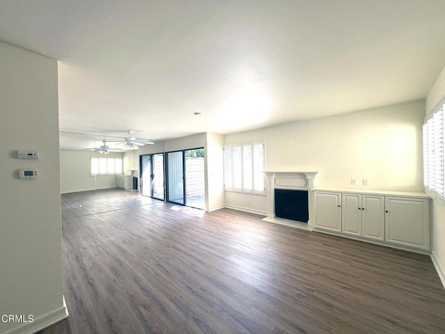 528 N Orange Grove Blvd, Pasadena, CA 91103 - unfurnished living room featuring plenty of natural light, dark wood finished floors, and baseboards
