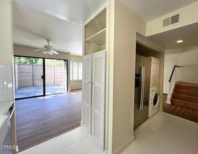 528 N Orange Grove Blvd, Pasadena, CA 91103 - laundry area with stacked washer / dryer, light tile patterned floors, ceiling fan, and baseboards