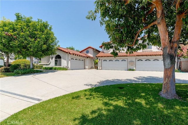 1049 Fairview Ave Unit 5, Arcadia, CA 91007 - view of front facade featuring concrete driveway, stucco siding, a front lawn, an attached garage, and a tiled roof