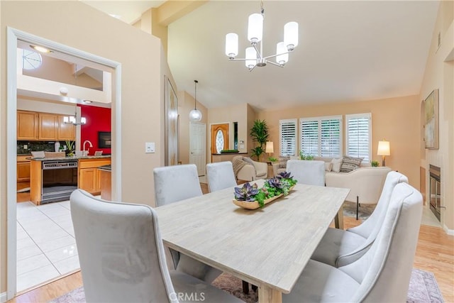 1049 Fairview Ave Unit 5, Arcadia, CA 91007 - dining area with a chandelier, high vaulted ceiling, and light wood-type flooring