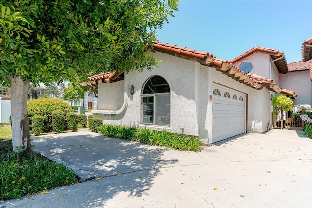1049 Fairview Ave Unit 5, Arcadia, CA 91007 - view of front of home featuring a garage, driveway, stucco siding, and a tile roof
