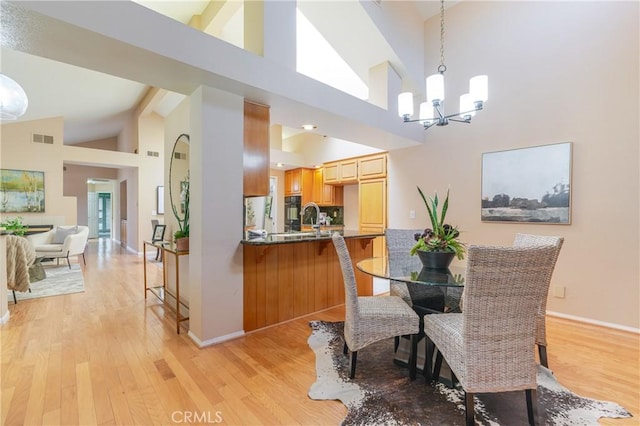 1049 Fairview Ave Unit 5, Arcadia, CA 91007 - dining room with a chandelier, high vaulted ceiling, light wood-style floors, and baseboards