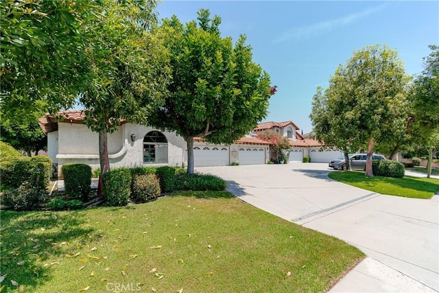 1049 Fairview Ave Unit 5, Arcadia, CA 91007 - view of property hidden behind natural elements featuring driveway, a front yard, stucco siding, and a garage