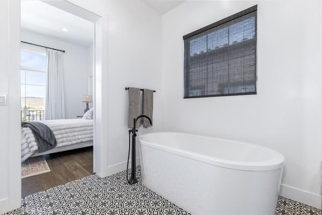 4029 Bernardo Dr, San Luis Obispo, CA 93401 - ensuite bathroom featuring a freestanding bath, baseboards, and wood finished floors