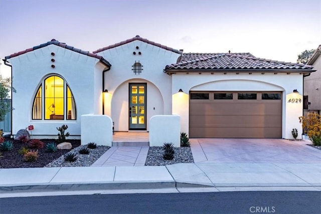 4029 Bernardo Dr, San Luis Obispo, CA 93401 - mediterranean / spanish home with an attached garage, driveway, stucco siding, and a tiled roof