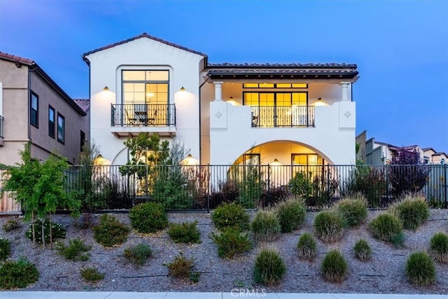 4029 Bernardo Dr, San Luis Obispo, CA 93401 - back of property featuring a balcony, a fenced front yard, and stucco siding