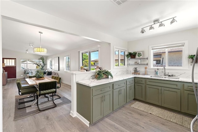 14911 Van Buren Ave, Gardena, CA 90247 - kitchen with a sink, light wood-style floors, a peninsula, and light stone counters