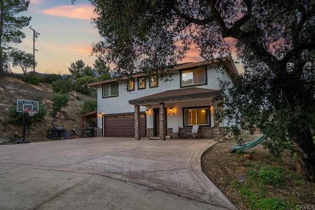 20591 Sycamore Springs Rd, Jamul, CA 91935 - view of front of house with stucco siding, a garage, concrete driveway, stone siding, and a porch