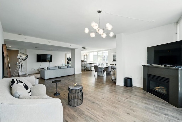510 First Ave Unit 402, San Diego, CA 92101 - living room featuring a chandelier, wood finished floors, and a glass covered fireplace